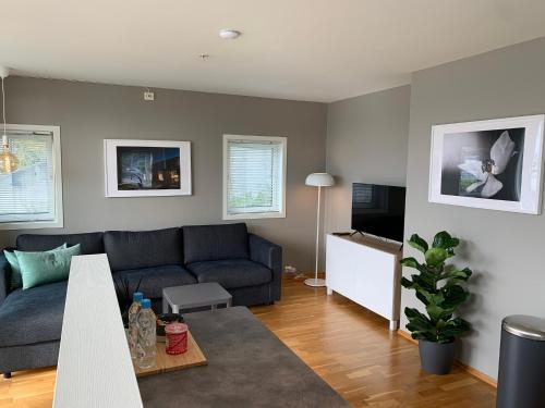a living room with a couch and a table at Modern apartment in the Harbour of Jørpeland in Jørpeland