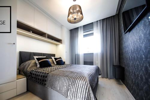 Posteľ alebo postele v izbe v ubytovaní Luksusowy apartament z tarasem