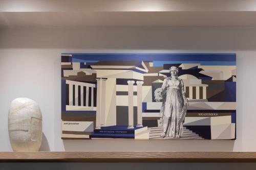 a painting of a statue on a wall in a museum at Muse Urban Suites in Athens