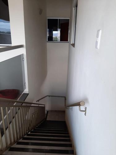 a stairway with a railing and a stair case at Casamatta Hostel - Unidade Aventura in Pirenópolis