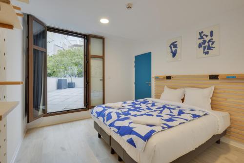 a bedroom with a large bed and a window at The People - Marseille in Marseille