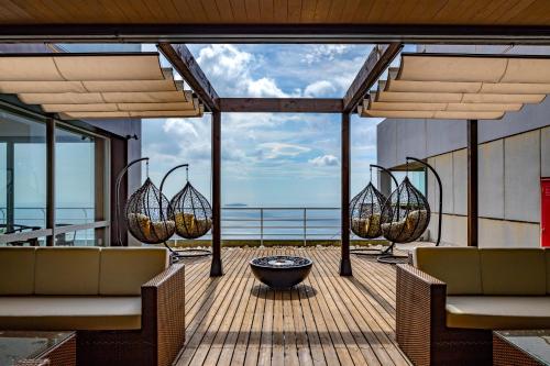 a deck with chairs and a fire pit on a ship at Ishinoya Atami - TKP Hotels & Resorts in Atami
