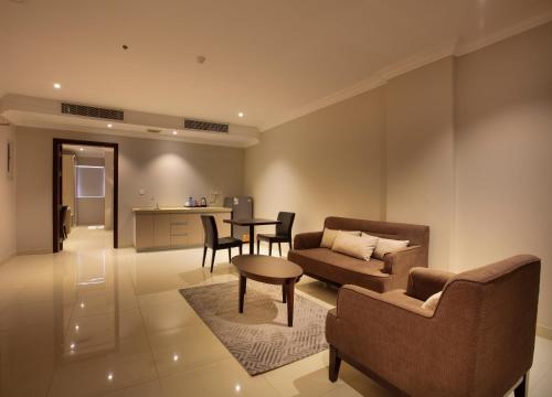 a living room with a couch and a table at SOMEDAYS Hotel Suites in Al Hofuf