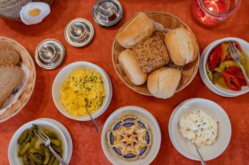 a table topped with bowls of different types of food at Apart Solaria - Wohnungen in Au-Schoppernau in Au im Bregenzerwald