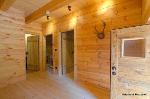 a log cabin with a wooden wall at Naturhaus Innviertel in Holzöster