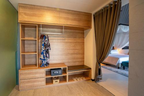 a room with a bedroom with a bed and a closet at Aston Anyer Beach Hotel in Anyer