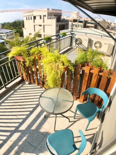 a patio with two chairs and a table on a balcony at A Day in Lukang Homestay in Lugang