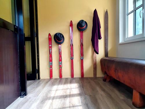 a row of baseball bats hanging on a wall at De nussi's chalet 3 in Bach
