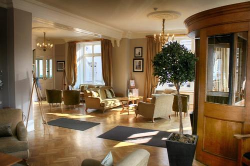 a living room with chairs and a table and a living room at The Bell Hotel in Sandwich