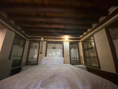 a bedroom with a large bed with a wooden ceiling at Kasr-ı Canan in Halfeti