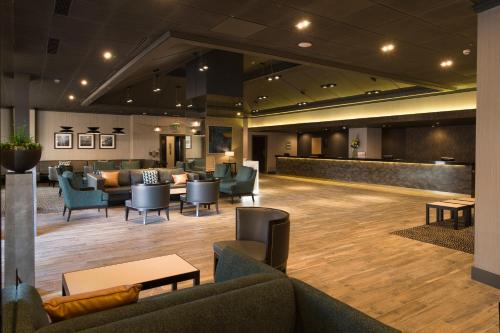 a lobby with couches and chairs and a waiting room at Crowne Plaza Harrogate by IHG in Harrogate