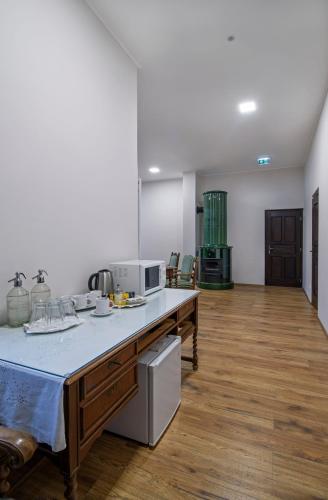 a large kitchen with a counter and a counter top at Szobi Malomkert Fogadó in Szob