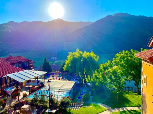 a view of a resort with a mountain in the background at Apartamentos Alquitara in Potes