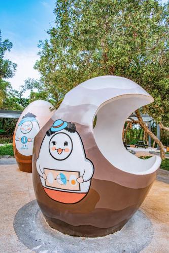 a sculpture of a penguin sitting on the moon at Minera Hot Springs Binh Chau in Binh Chau