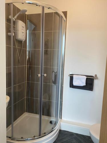 a shower with a glass door in a bathroom at Be My Guest Liverpool in Liverpool