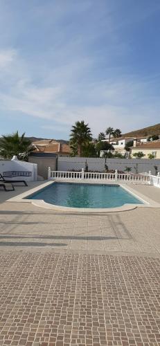a swimming pool in the middle of a courtyard at Los Torres Casa Lindsay in Arboleas
