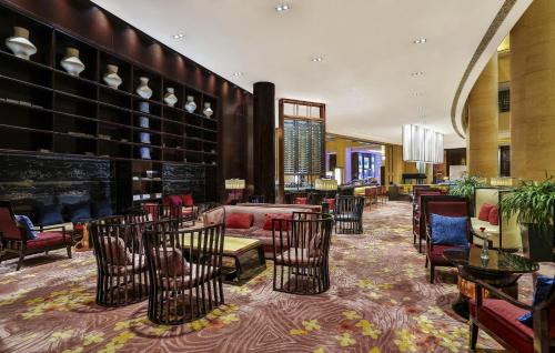 a lobby with chairs and tables in a building at Crowne Plaza Chengdu Panda Garden by IHG-Near Panda Base in Chengdu