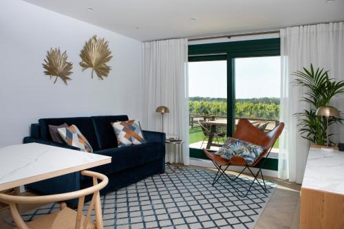 a living room with a couch and a table at Villas Finca La Emperatriz in Baños de Rioja