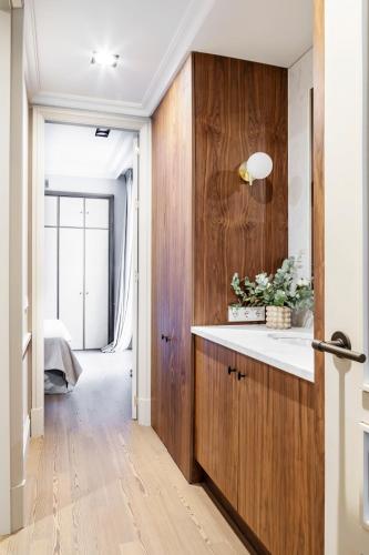 a kitchen with wooden cabinets and a white counter top at Ayala 63 - THE ARC COLLECTION in Madrid
