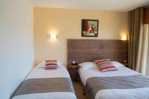 Arc Hôtel Sur Merにあるベッド