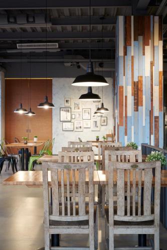 a restaurant with a table and chairs and pendant lights at Reikei Hot Spring Resort in Baihe