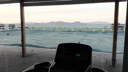a view of a tennis court from a window at La Rosa dei Venti Resort in Piombino