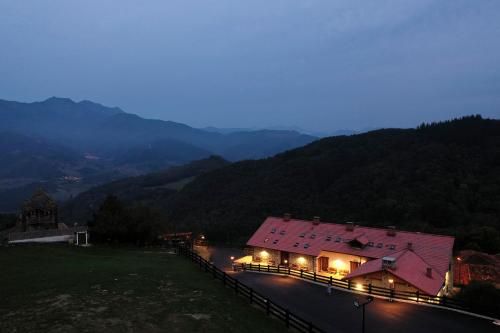 a large building with lights on top of a mountain at Apartamentos Los Picos de Europa in Colio