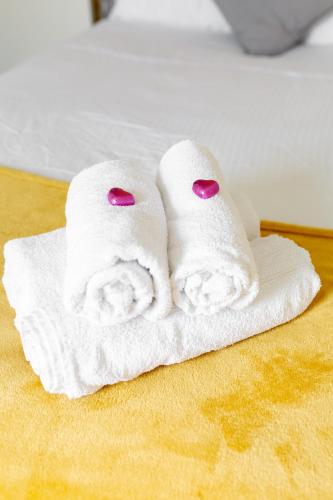 two towels sitting on top of a bed at Comfortable Liverpool Townhouse - FREE parking in Liverpool