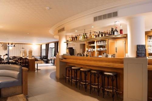 a bar in a restaurant with bar stools at Castelnou Aparthotel in Ghent