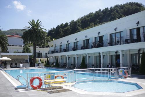a hotel with a swimming pool in front of a building at Northdoor Hotel in Amasra