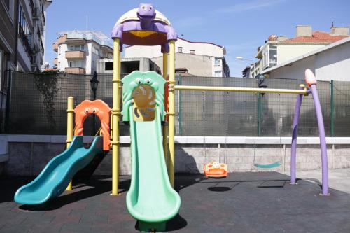a playground with two slides and a slide at Northdoor Hotel in Amasra