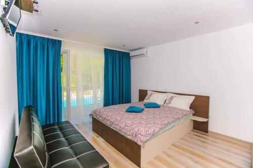 a bedroom with a bed with blue pillows on it at La Păstrăvărie in Mehadia
