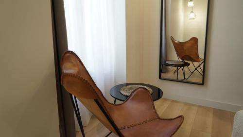 a room with two chairs and a mirror at MD Design Hotel - Portal del Real in Valencia