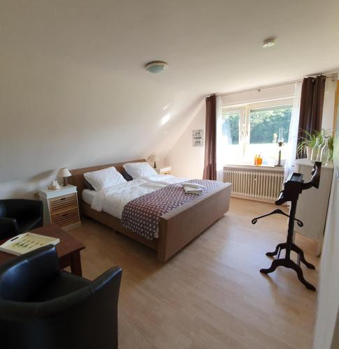 a bedroom with a bed and a desk with a camera at B&B Die Herrlichkeit in Lage