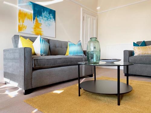 a living room with a couch and a table at Tay View Apartment in Dundee