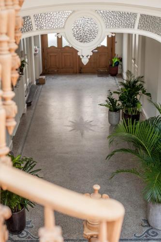 a hallway with potted plants in front of a building at B'Guest Sleep & Retreat in Bruges