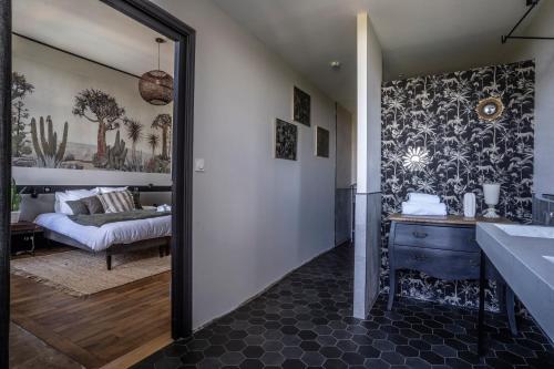 a bathroom with a mirror and a bed in a room at Le Château des Forges in Angers