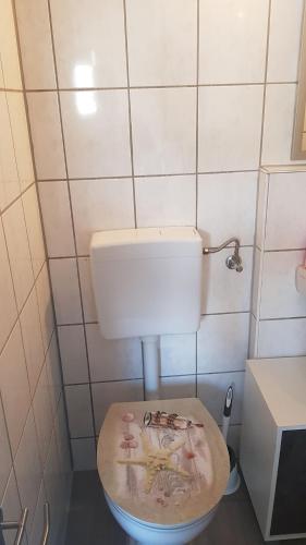 a bathroom with a toilet with the lid down at Flensburg City - 24h in Flensburg