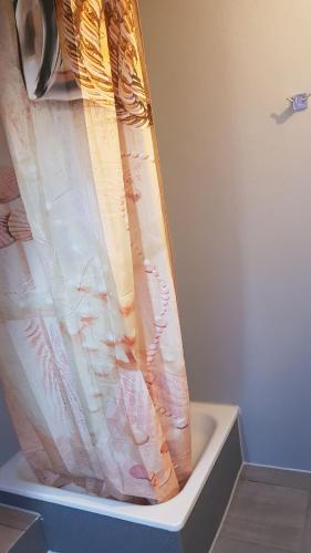 a shower curtain sitting on top of a toilet at Flensburg City - 24h in Flensburg