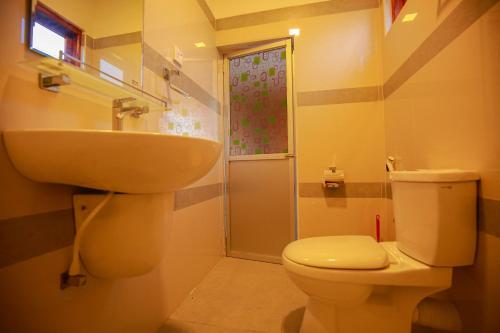 a bathroom with a sink and a toilet and a shower at Yala Elephant Cottage in Tissamaharama