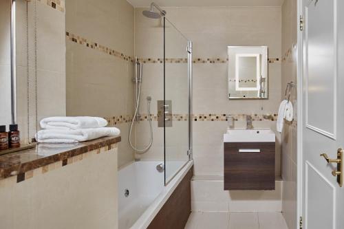 a bathroom with a shower and a sink at Arlington House Apartments in London