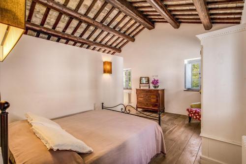 a bedroom with a bed and a dresser and a window at Villa Benedetta - Homelike Villas in Osimo