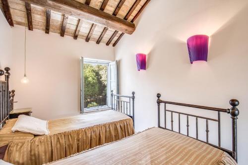 two beds in a room with a window at Villa Benedetta - Homelike Villas in Osimo