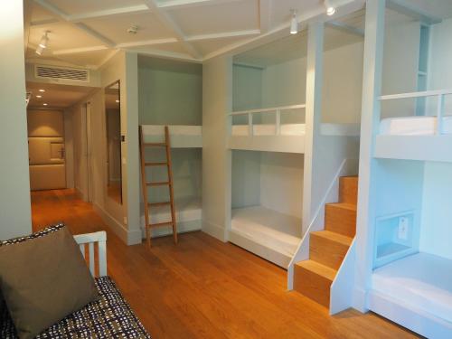 a room with bunk beds and a staircase in it at Jugend- und Familienhotel Augustin in Munich