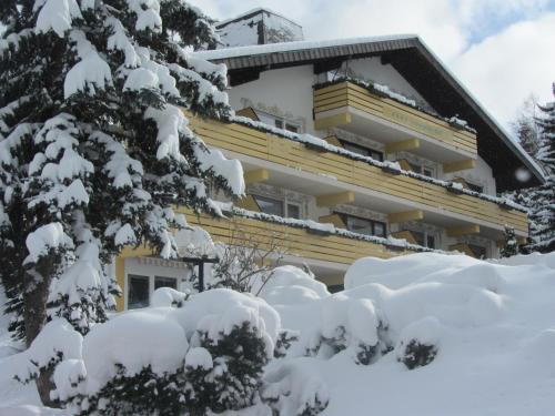 a building covered in snow with snow covered trees at Forsters Schwarzwald Hof - Resort-Hotel&Pension in Feldberg