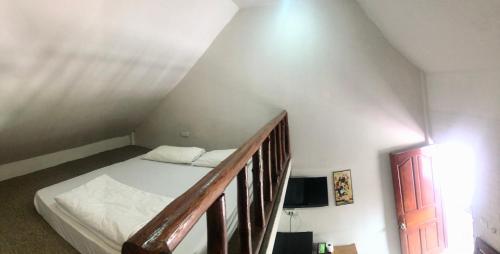 a bedroom with a bed and a stair case at Baan Lanna Resort in Chon Buri