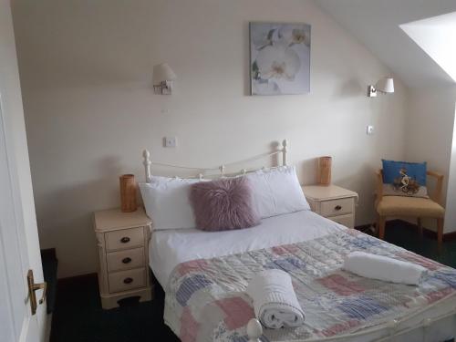 a bedroom with a bed and two night stands at The Carthouse in Aberystwyth