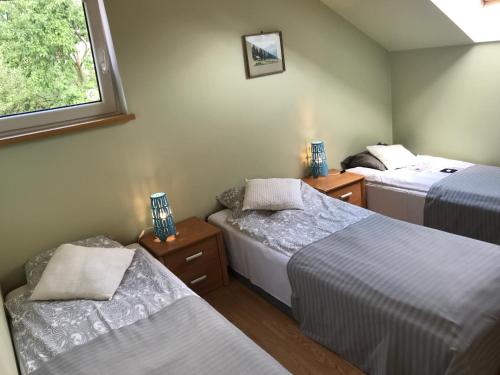 A bed or beds in a room at APARTAMENTY-STUDIO noclegi wczasy wakacje ferie - pobyty rodzinne