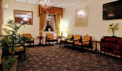 a waiting room with chairs and a chandelier at Gleneagles - Albert Road in Blackpool
