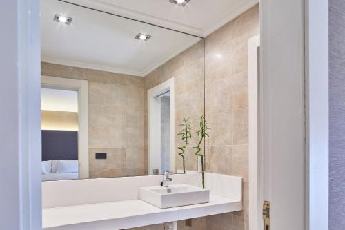 a bathroom with a sink and a mirror at Silken Gran hotel Durango in Durango